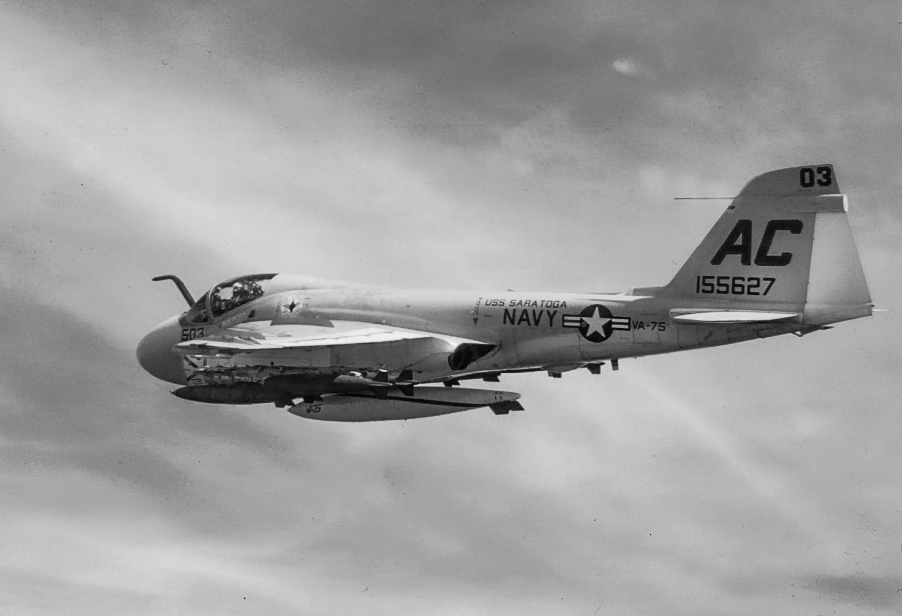 A black-and-white photograph of a Navy A-6 Intruder from VA-75 in flight.