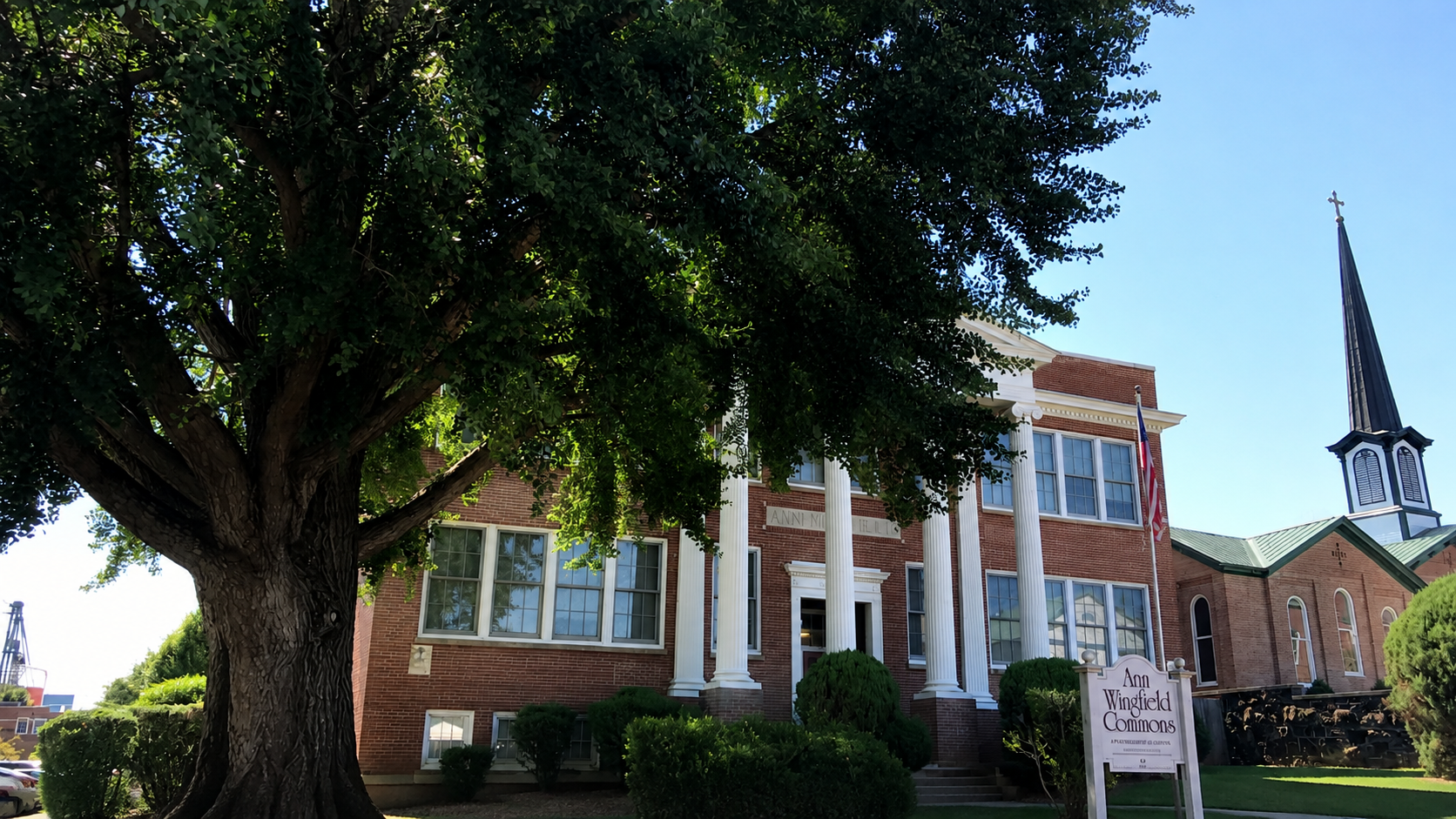 The historic red-brick Ann Wingfield School building in Culpeper, Virginia, with white columns and the Ann Wingfield Commons sign.